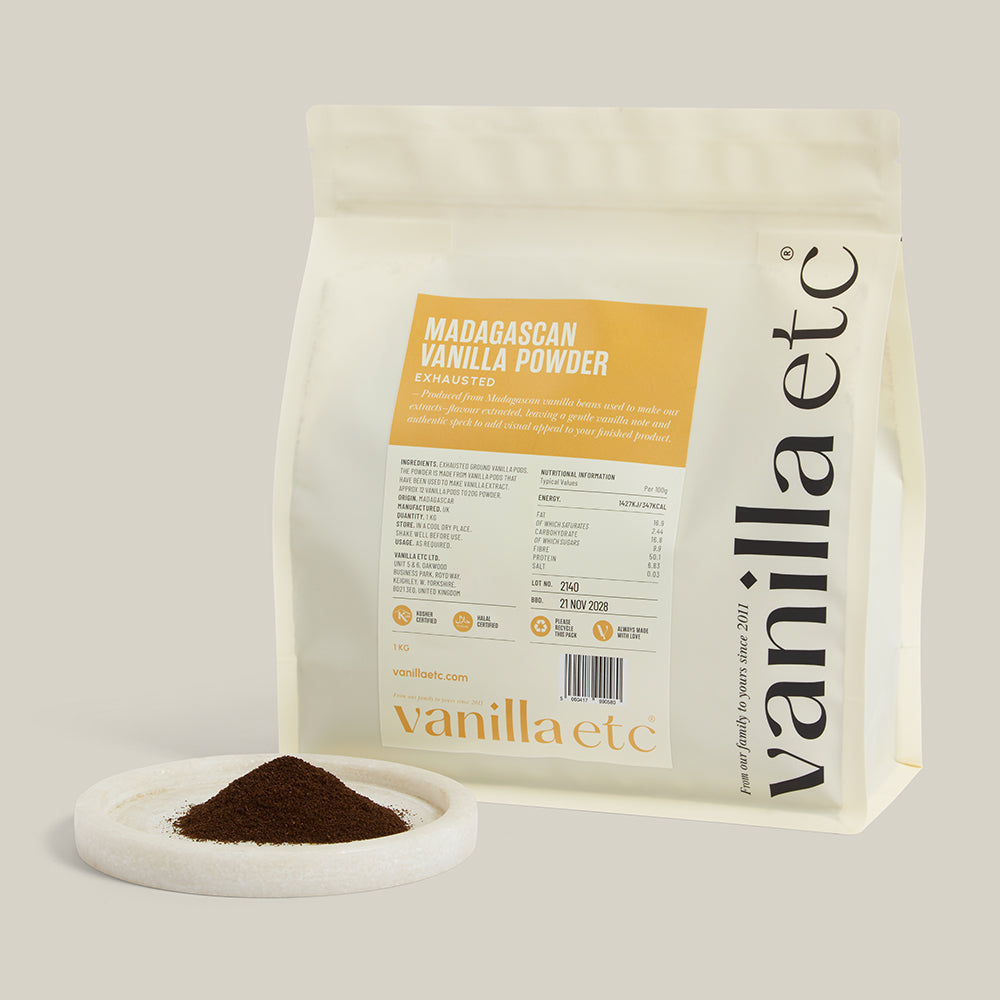 Vanilla powder packaging with a small scoop of powder on a white background