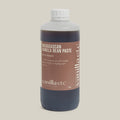 1 kg bottle of Madagascan Vanilla Bean Paste with Seeds by vanilla etc on a cream background