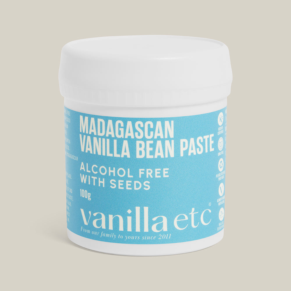 Jar of Madagascan Vanilla Bean Paste with a blue label on a beige background