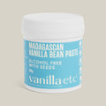 Jar of Madagascan Vanilla Bean Paste with a blue label on a beige background