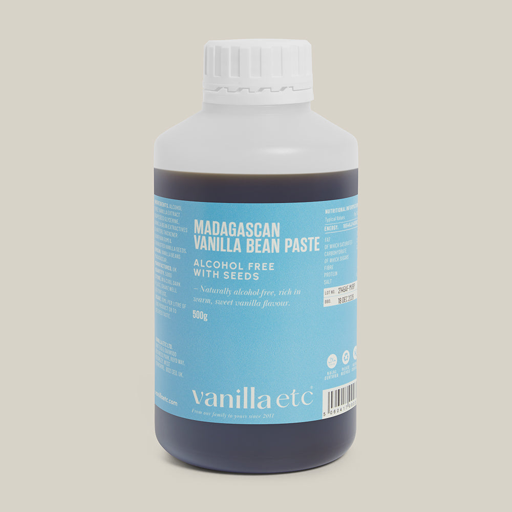 Bottle of Madagascan Vanilla Bean Paste with a blue label on a beige background