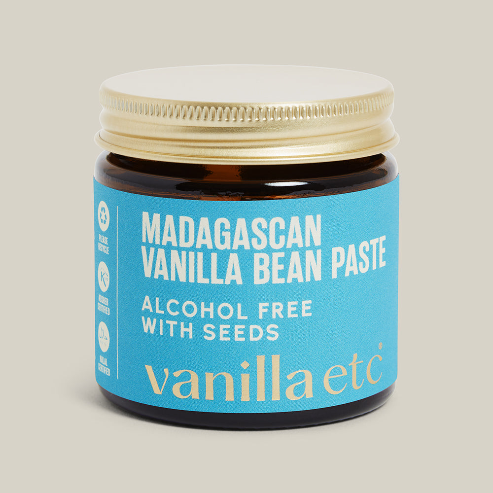 Jar of Madagascan Vanilla Bean Paste with blue label on beige background