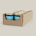 Box of Madagascan Vanilla Bean Paste jars with gold lids on a beige background