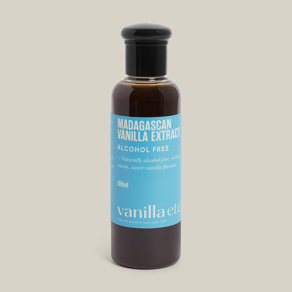 Bottle of Madagascan Vanilla Extract with a blue label on a beige background