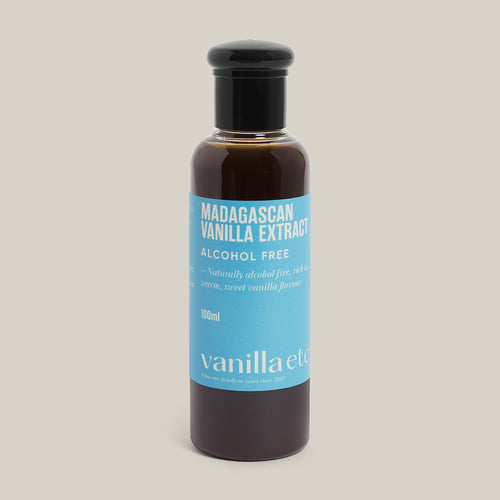 Bottle of Madagascan Vanilla Extract with a blue label on a beige background