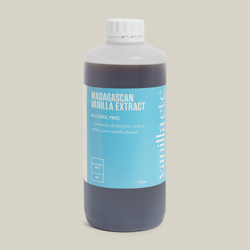 Bottle of Madagascan vanilla extract with a blue label on a beige background