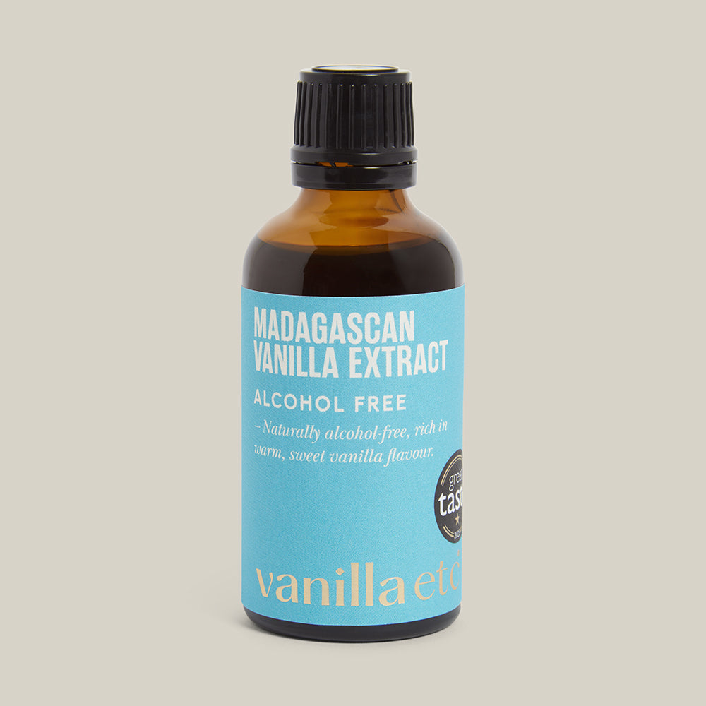 Bottle of Madagascan Vanilla Extract with a blue label on a cream background