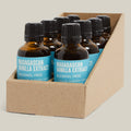 Box of Madagascan Vanilla Extract bottles with blue labels on a cream background