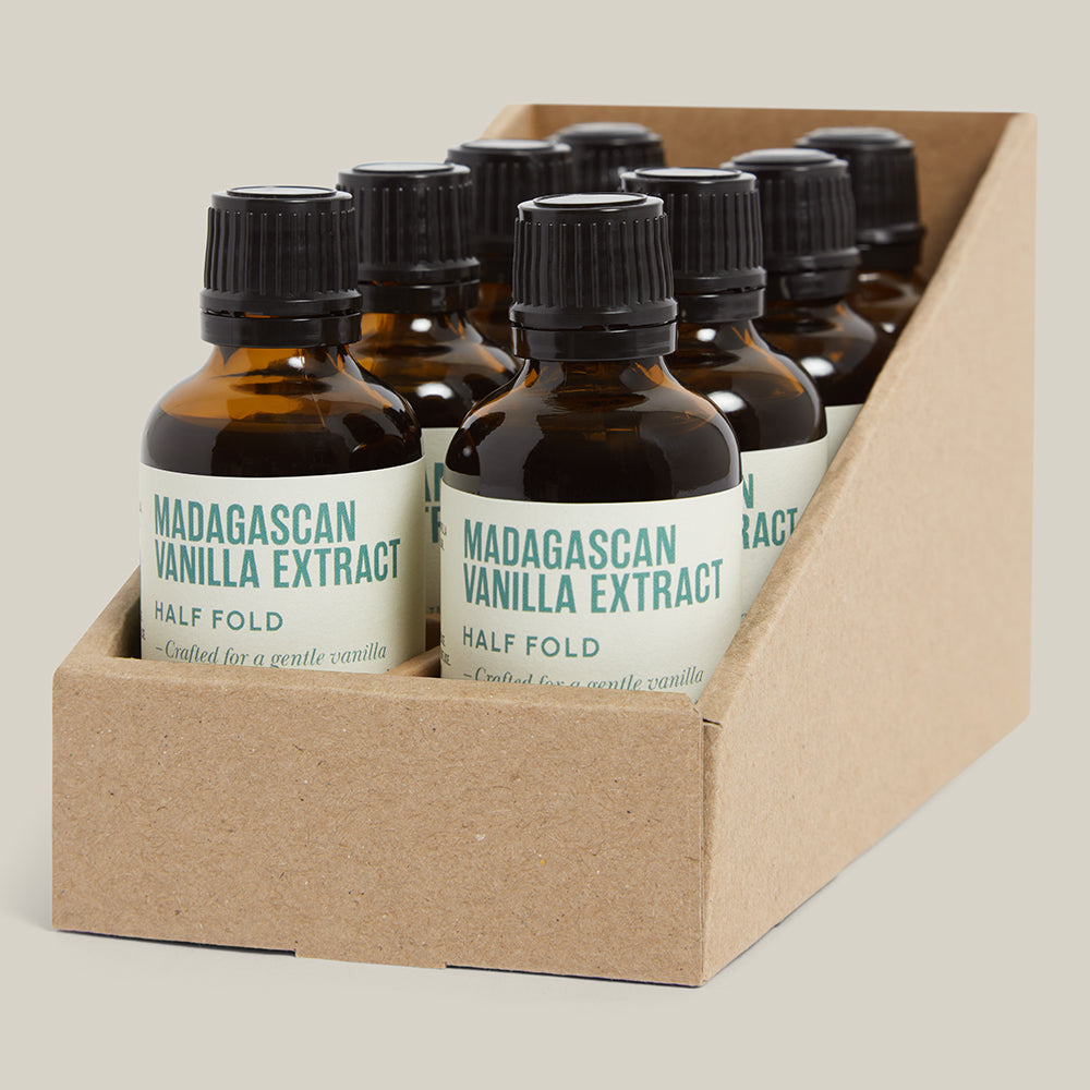 Box of Madagascan Vanilla Extract bottles on a beige background