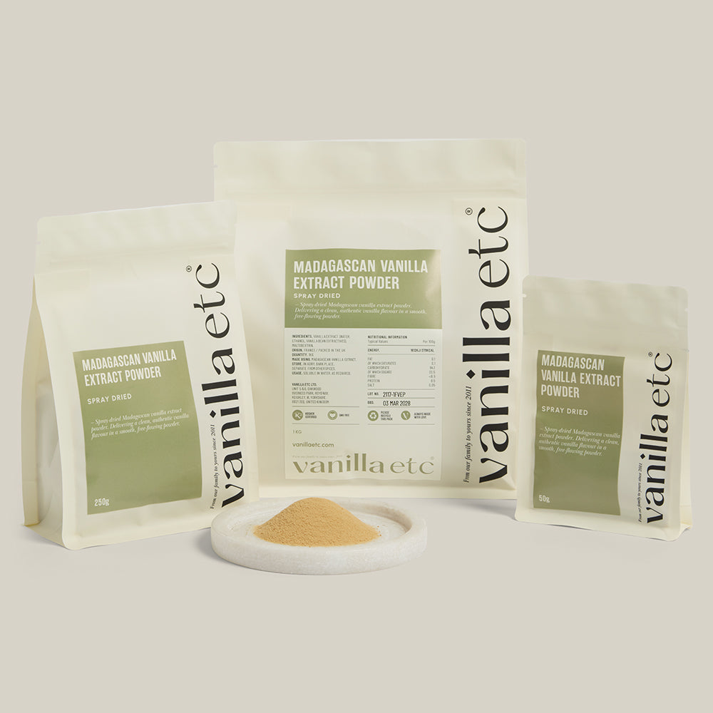 Vanilla extract powder packaging with a small amount of powder on a white surface