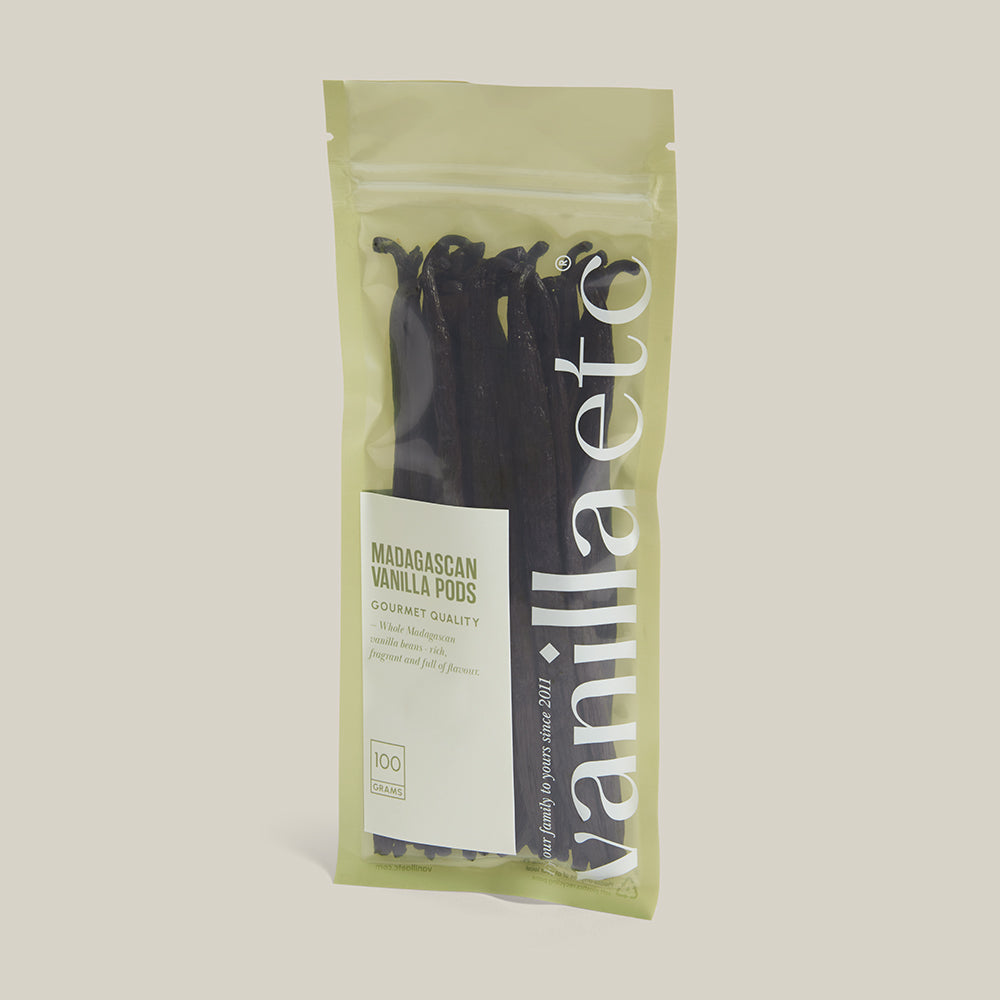 Packaged vanilla pods with a visible brand label on a neutral background