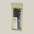 Packaged vanilla pods with a visible brand label on a neutral background