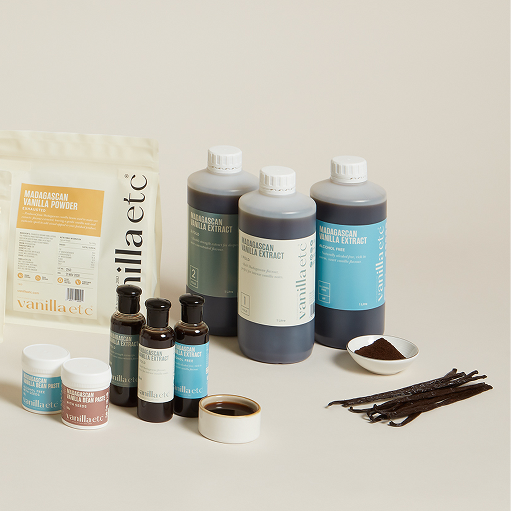 Collection of vanilla extract products and ingredients on a light background